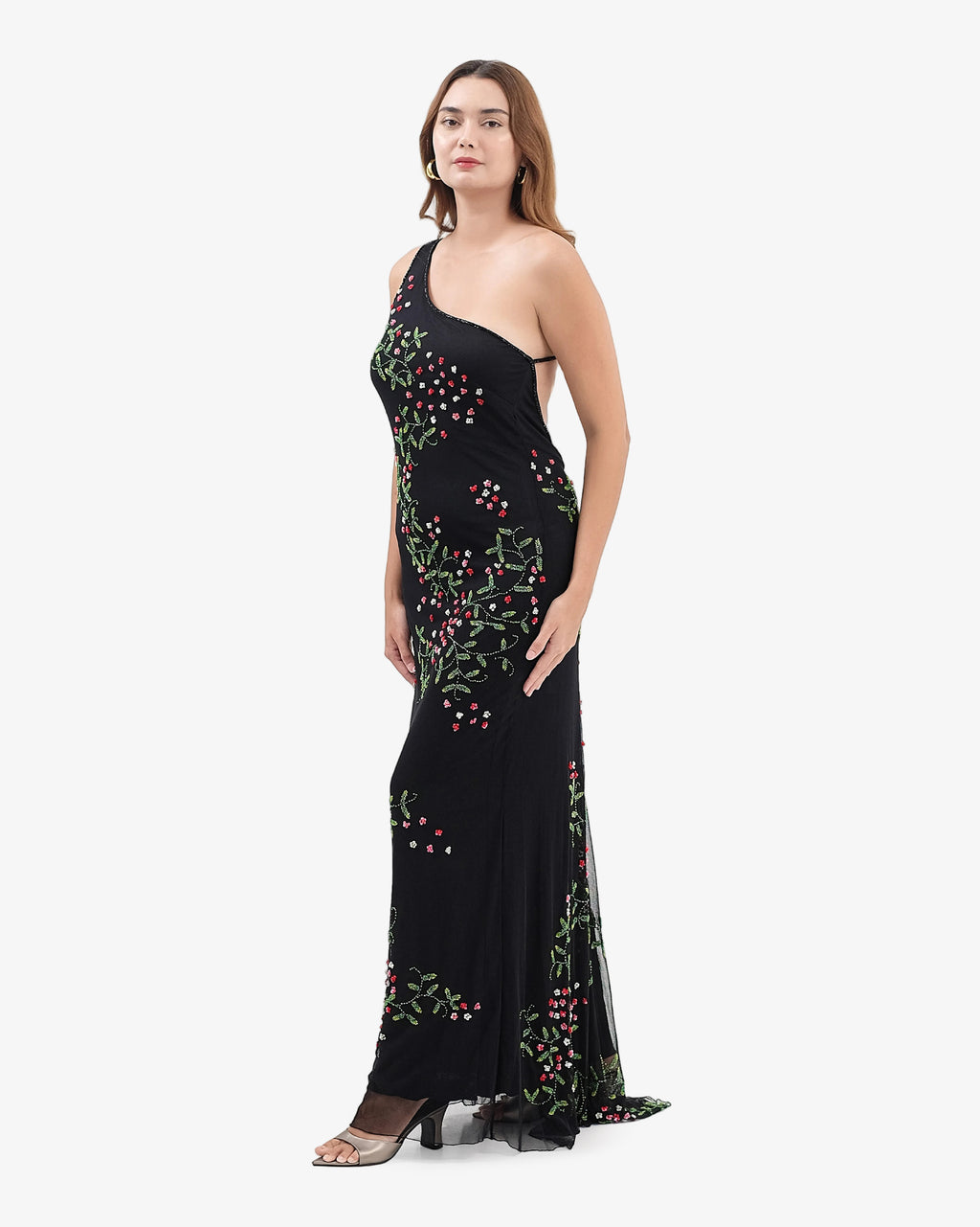 Woman wearing a black dress with floral embroidery on a white background