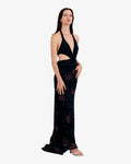 Woman wearing a black floral dress on a white background