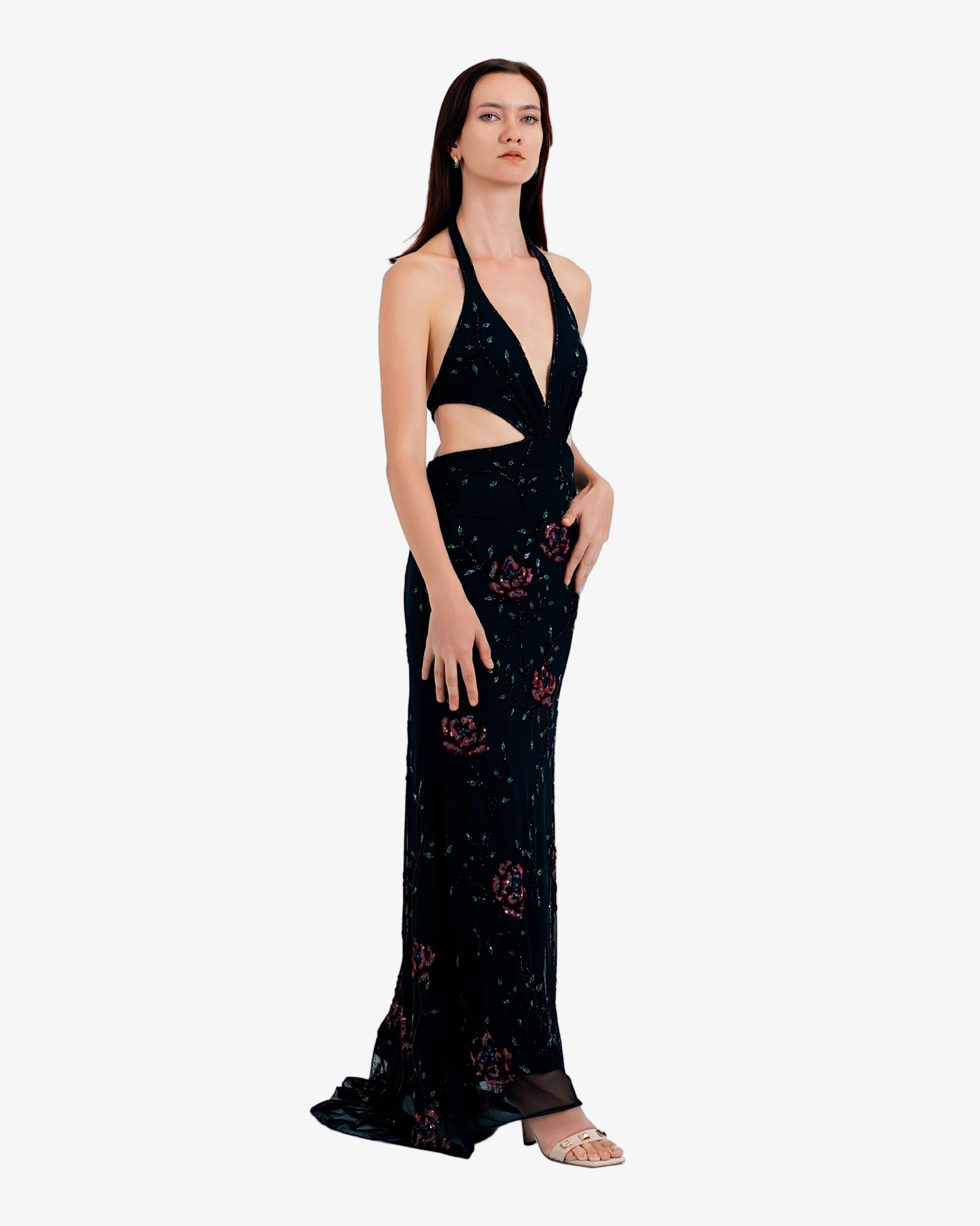 Woman wearing a black floral dress on a white background