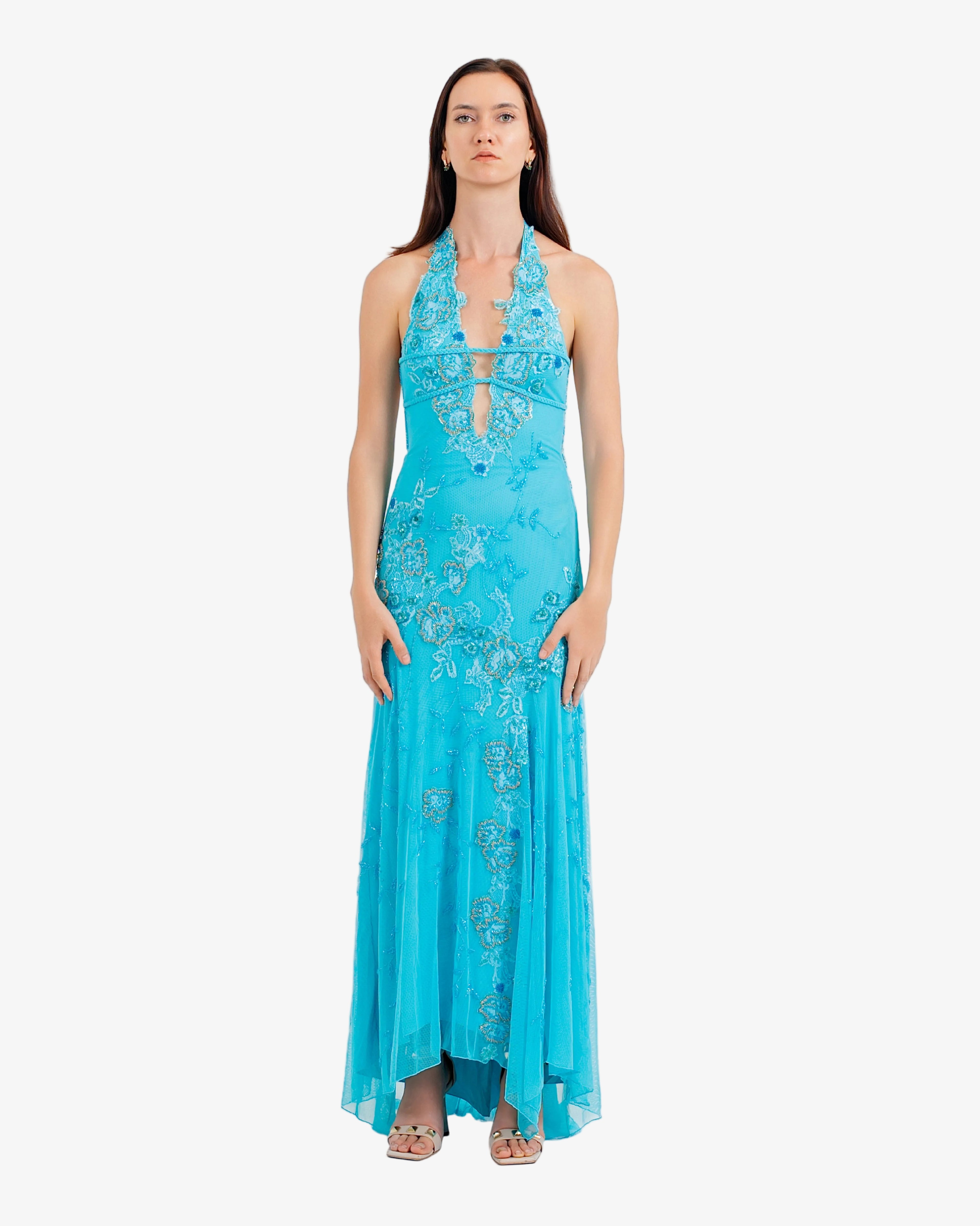 Woman wearing a blue floral dress on a white background