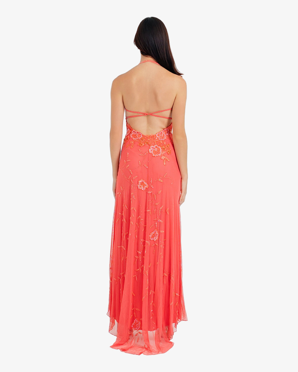 Woman wearing a red floral dress on a white background