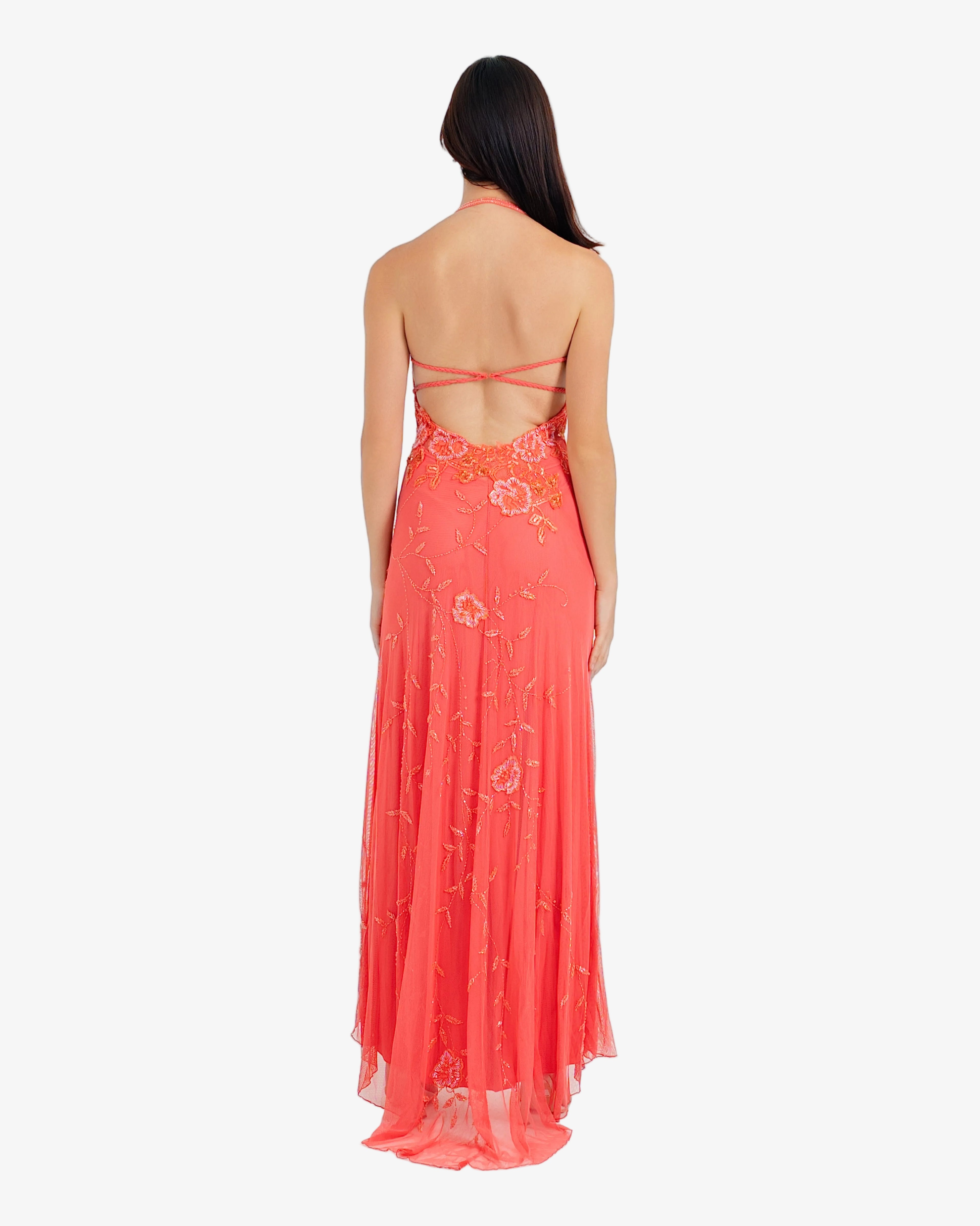Woman wearing a red floral dress on a white background