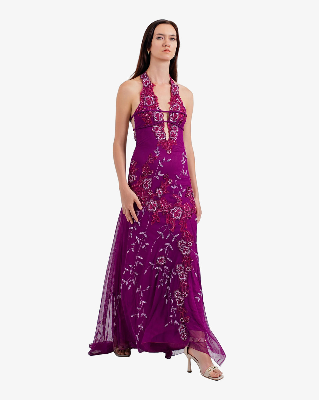 Woman wearing a purple floral dress on a white background