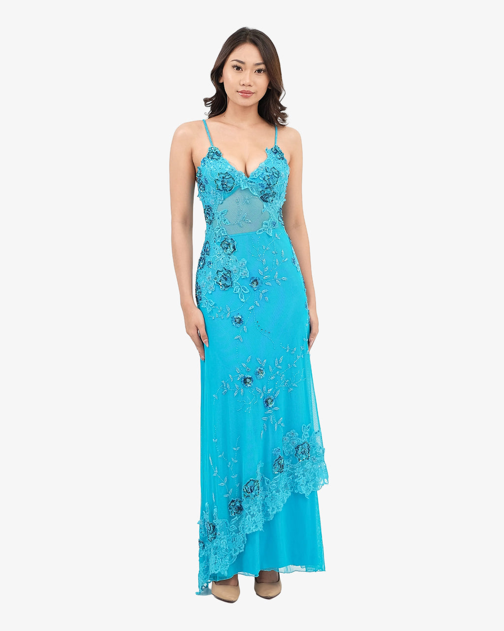 Woman wearing a Turquoise evening gown with floral embroidery on a white background