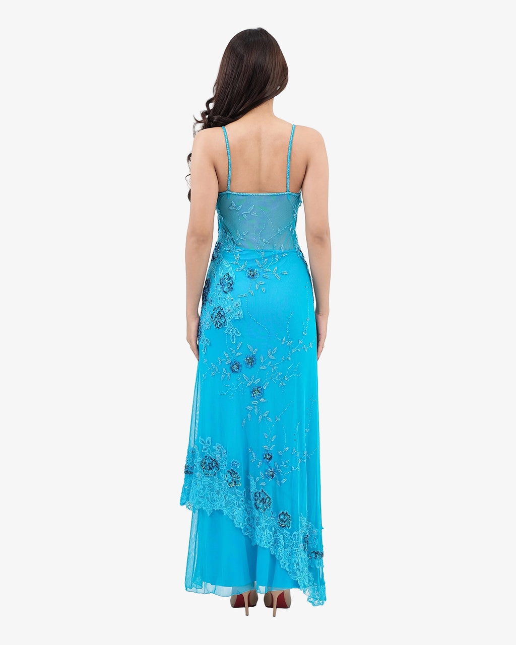 Woman wearing a Turquoise evening gown with floral embroidery on a white background